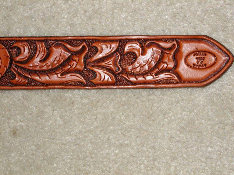 Floral carved belt with Texas conchos